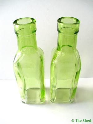 small green glass bottles from the craft store, perfect as bud vases