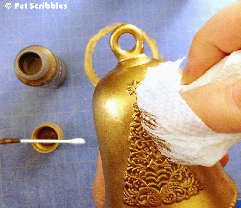 Applying Dazzling Metallics in Renaissance Brown onto a gold gilded ornament.