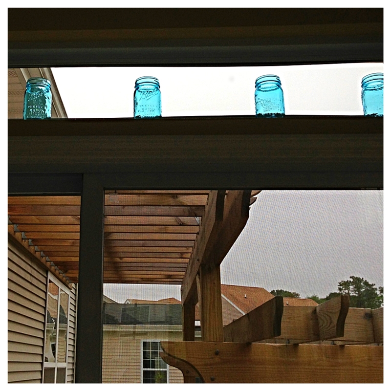 Blue Ball Mason Jars from their Heritage Collection displayed in a transom window!