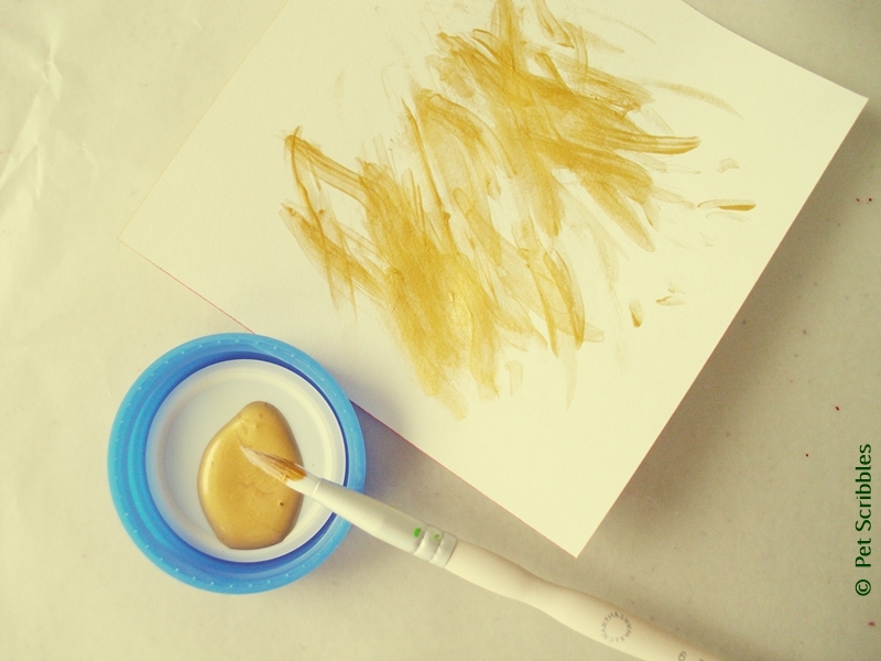 gold metallic paint is applied with fine-tip brush with most of the paint already removed