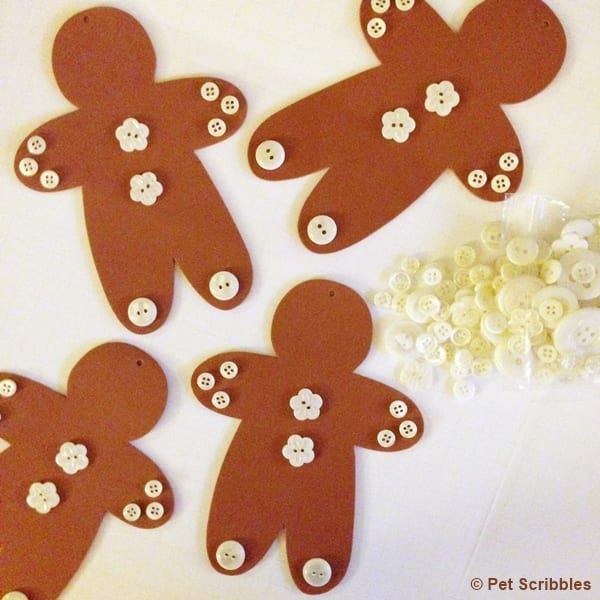 use glue to attach buttons on foam gingerbread men ornaments