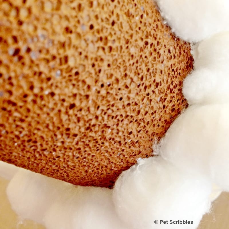 cotton balls being glued to a Styrofoam cone