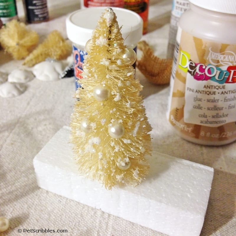attaching ornaments to bottle brush tree