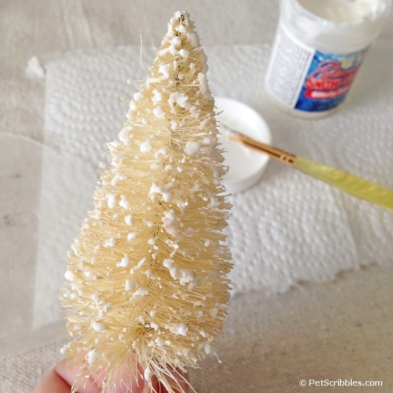 painting fake snow on bottle brush tree