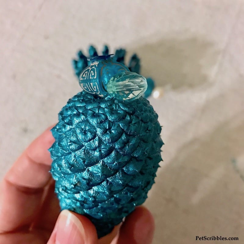 image shows beads glued to a painted pinecone ornament