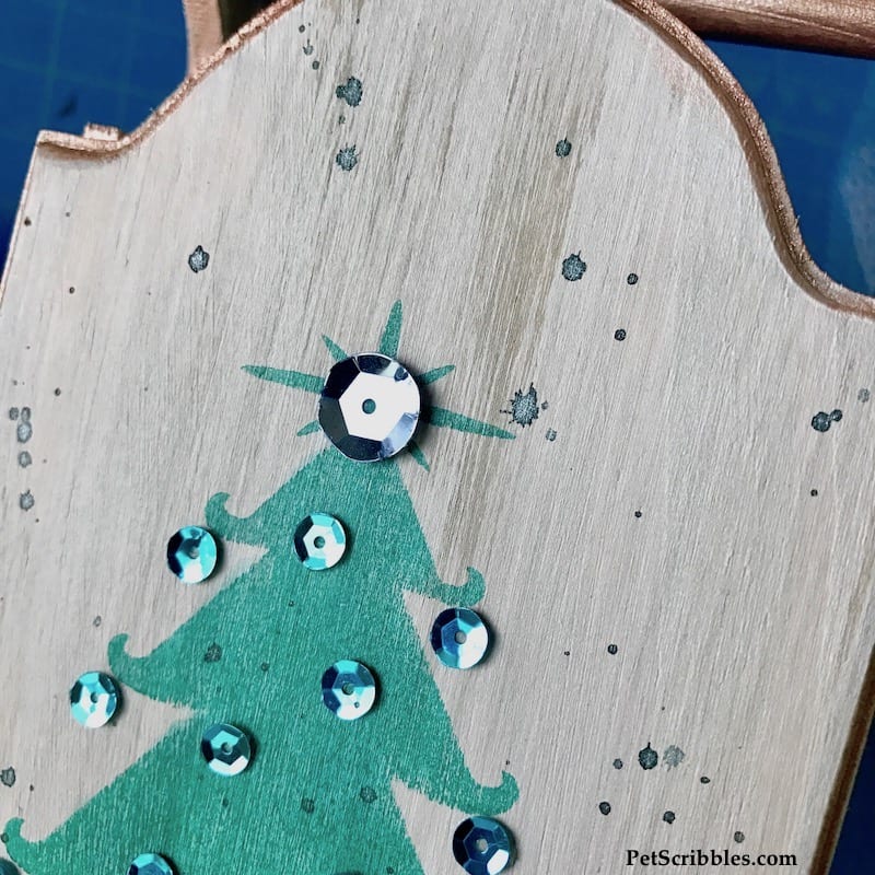 small droplets of watered-down paint splattered across wood surface