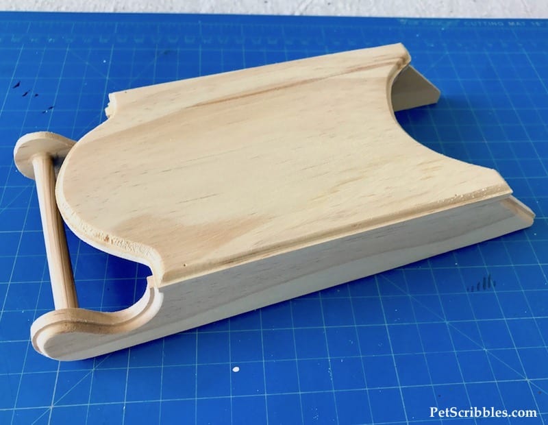 an unfinished wood sled from the craft store