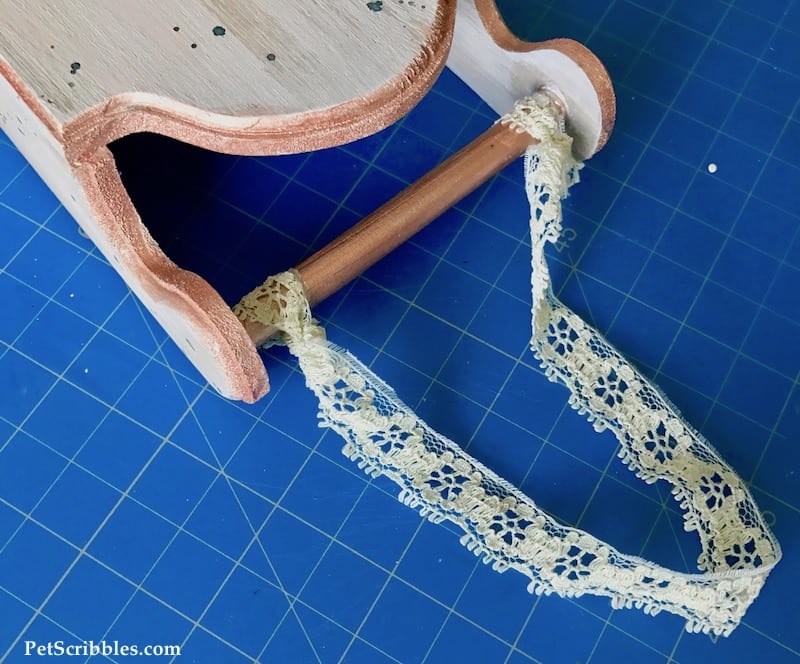 lace scrap used as a hanger for a rustic wood sled decoration