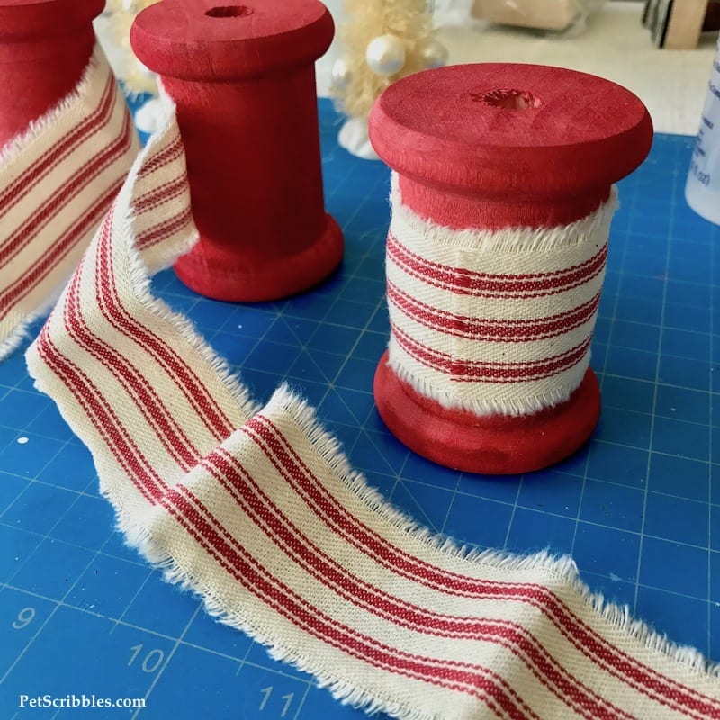 red spools with red/ivory ticking fabric in foreground