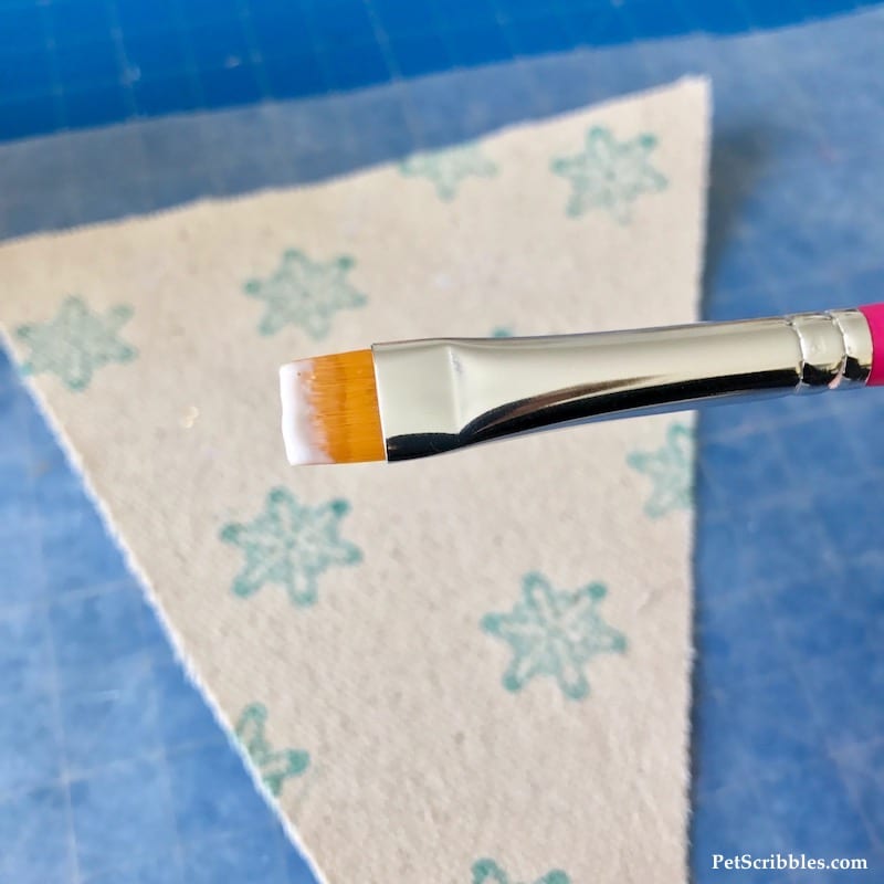 adding sparkle Mod Podge to canvas pennant