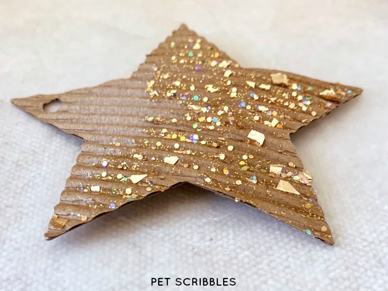 making glitter cardboard star ornaments