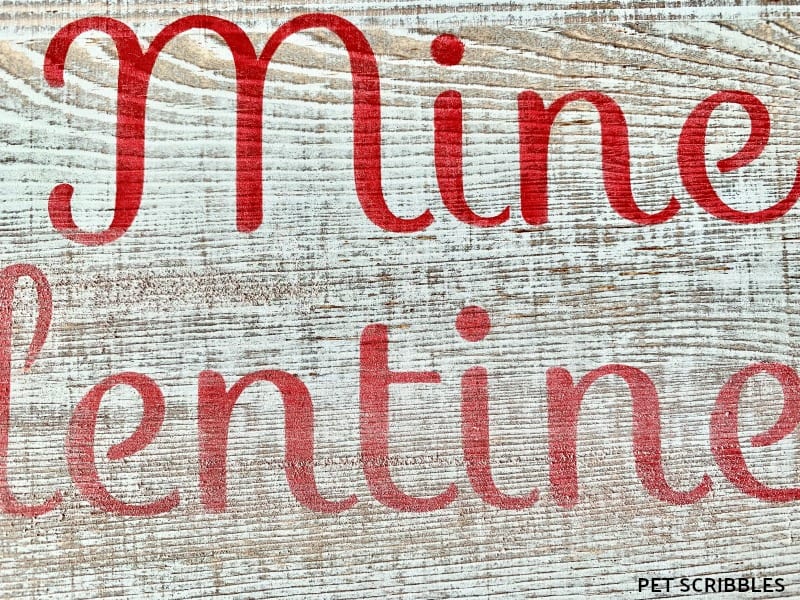 sanding a rustic Valentine's Day sign