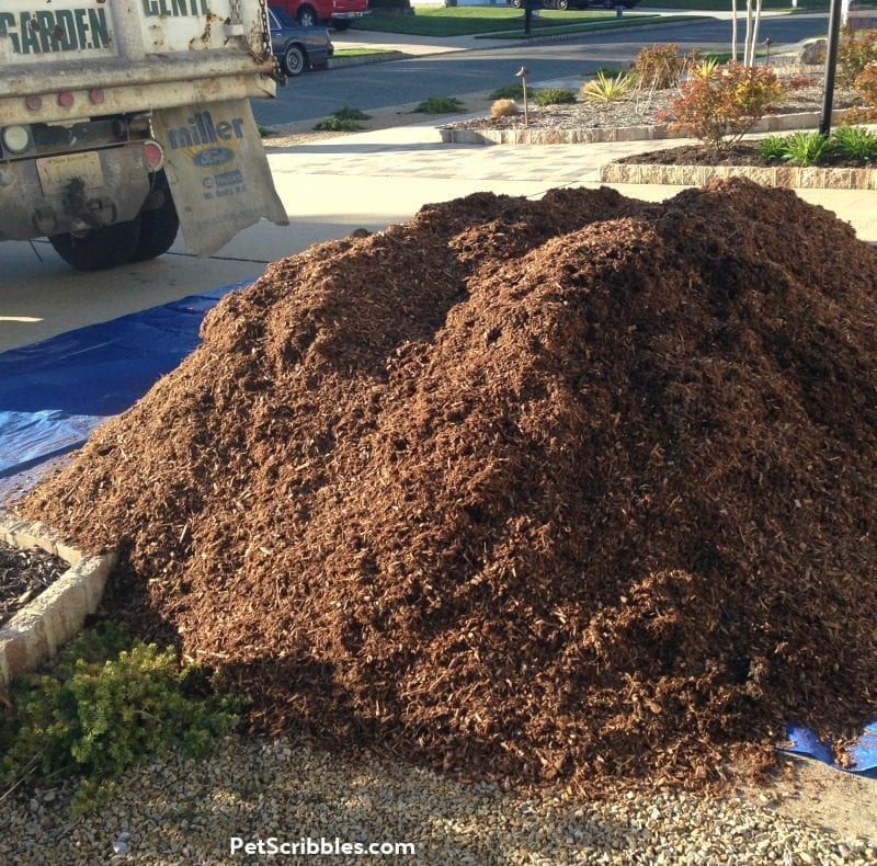 garden mulch on a tarp in the driveway