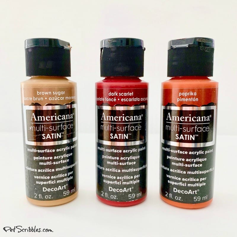 three bottles of DecoArt brand multi-surface craft paint