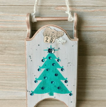 a rustic painted wood sled for Christmas