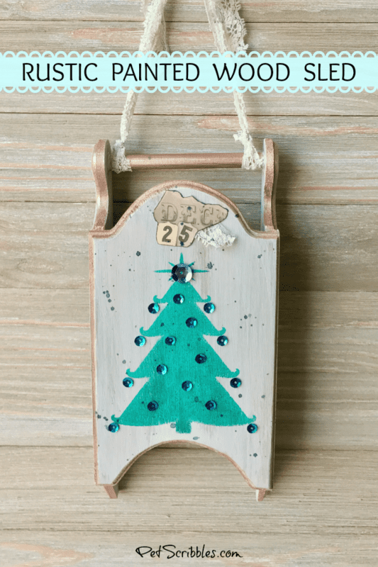 a rustic painted wood sled for Christmas