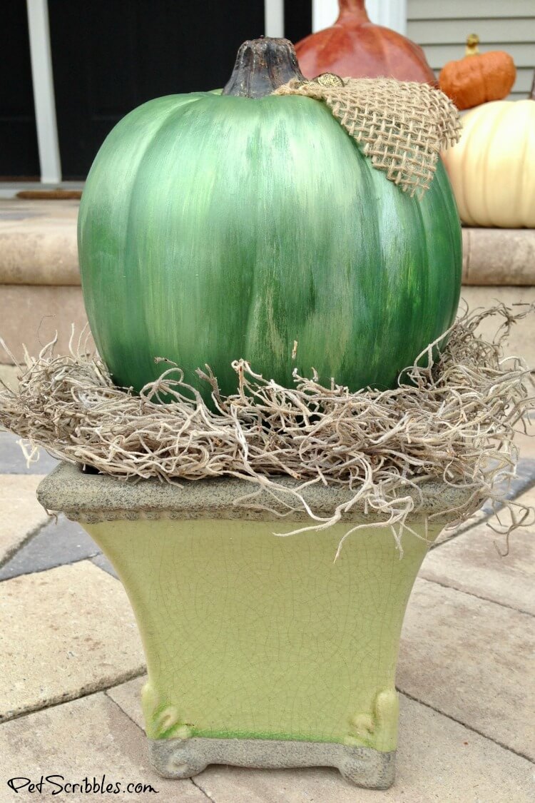 green mercury glass pumpkin in a vintage urn