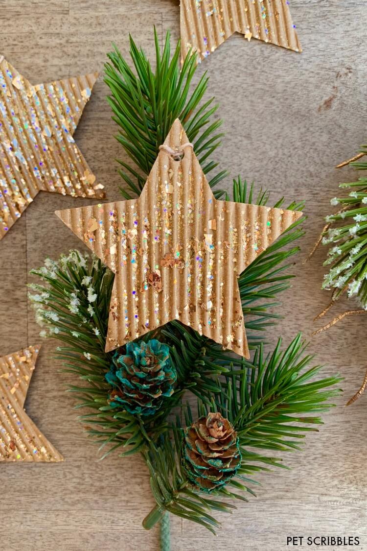 corrugated cardboard glitter star ornament on holiday greenery