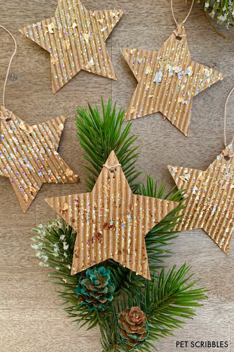 DIY glitter cardboard star ornaments and decorative holiday greenery