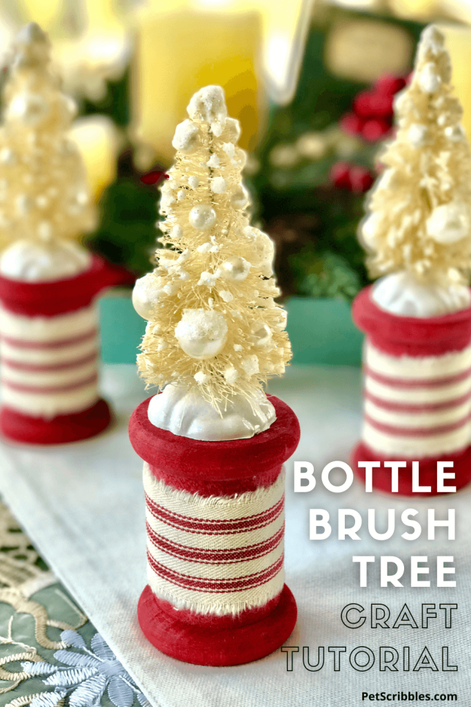 ivory bottle brush trees on red spools in Christmas tabletop display